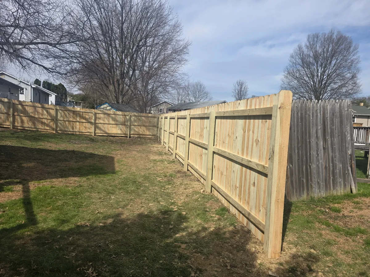Wood privacy fence along residential backyard property