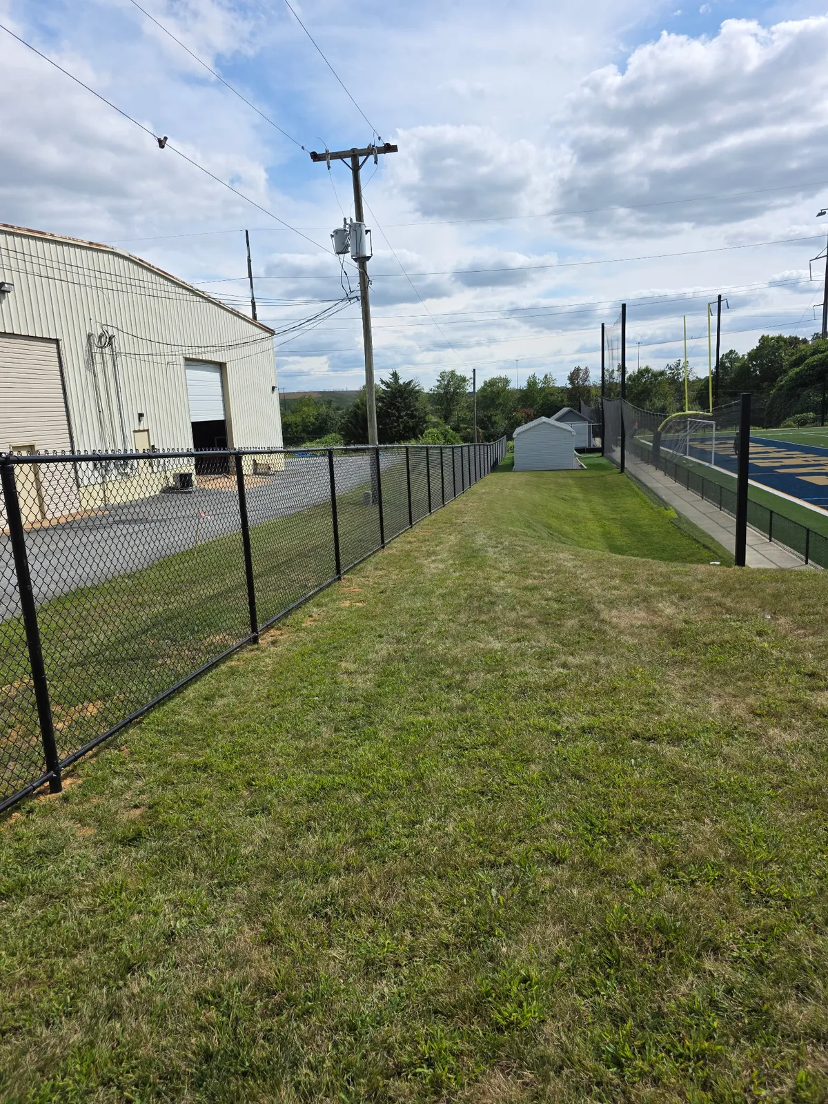 Black chain link fence at sports facility