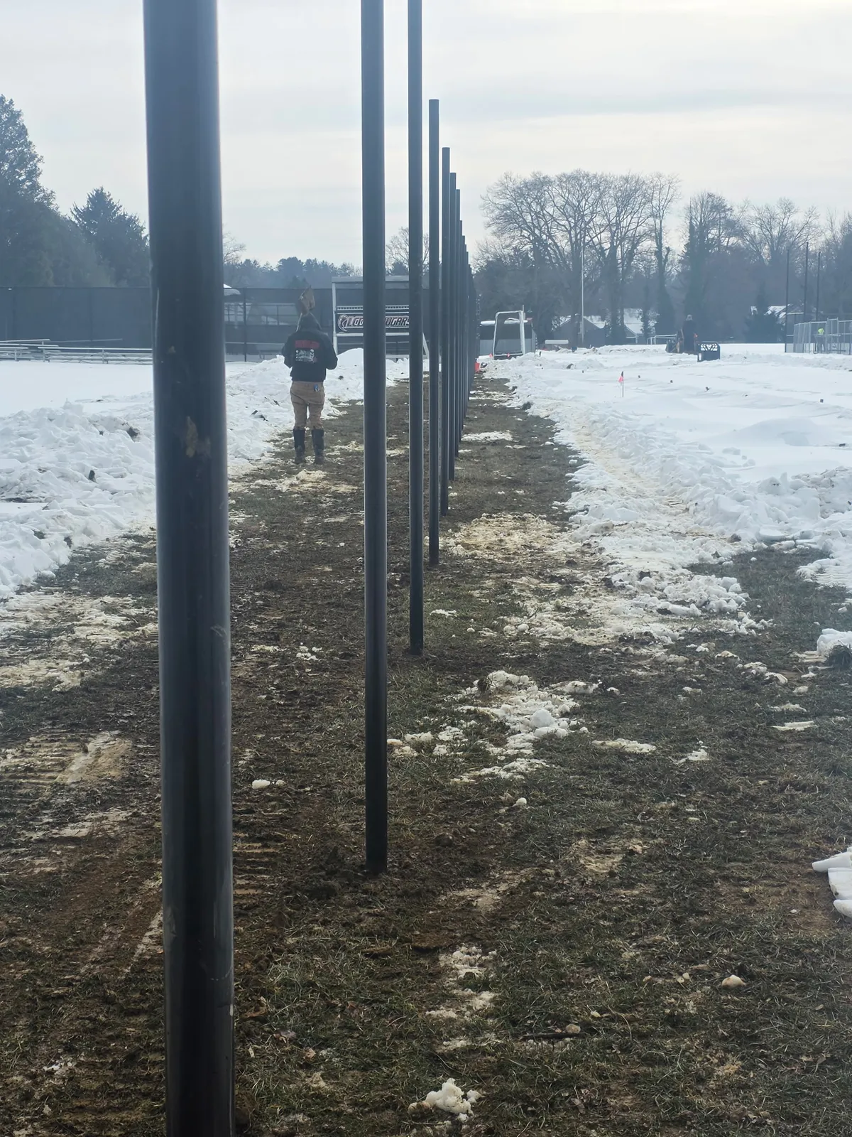 Galvanized chain link fence stretching across large open field